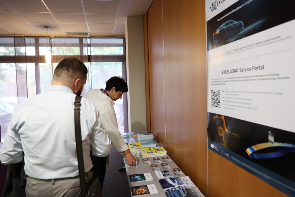 EXCELLERAT P2 exhibition area at SOR, side view of some interested visitors.